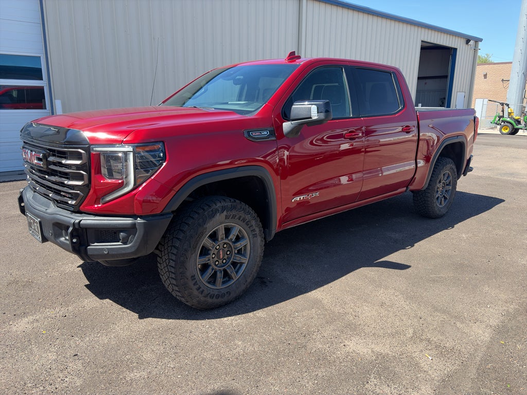 2024 GMC Sierra 1500 AT4X in Volcanic Red Tintcoat — front three-quarter view